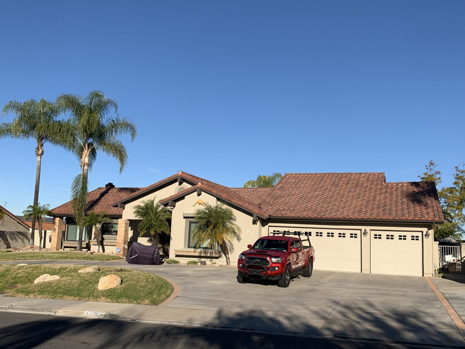 A red car parked in front of a house.